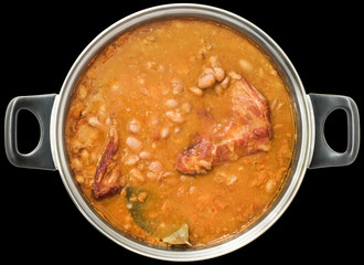 Beans Baked With Smoked Pork Ribs In Old Stainless Steel Saucepot Isolated On Black Background