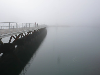 Obraz premium people on a bridge in the fog in Lisbon in Portugal