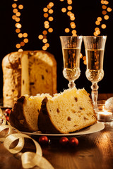Sliced italian panettone, sparkling wine and decorations