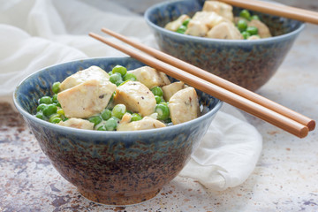 Fried chicken with green peas in cream sauce, served with rice, horizontal