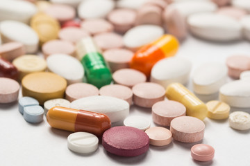 Multiple pills depicting medical treatment or pahrmaceutical ind