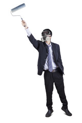 Obraz premium Businessman with gas mask and paint roller