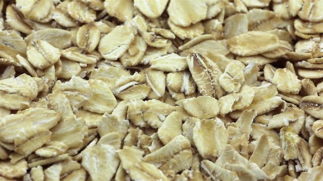 Rotating rolled oats flakes closeup