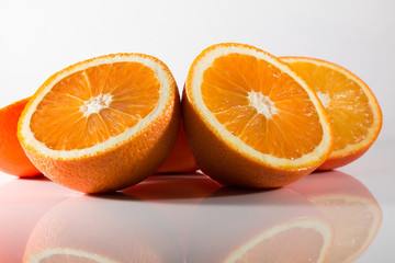 Oranges cut in half isolated against a white background