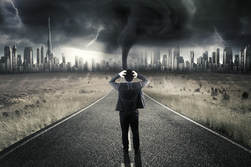 Stressful entrepreneur standing on road with storm