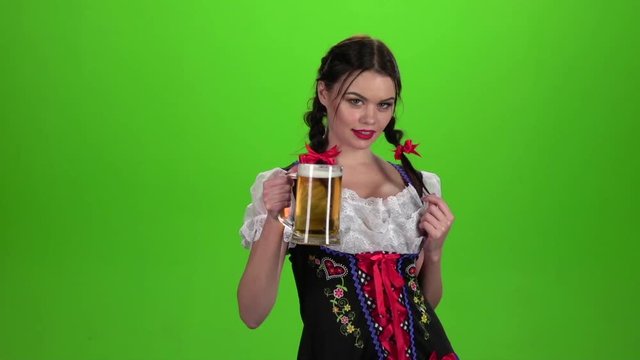 Girl Oktoberfest sexually attracts and licks his lips. Green screen