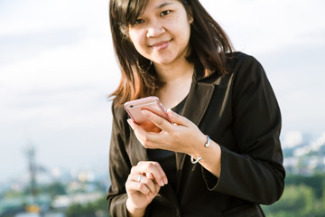 Happy Asian Businesswoman talking on smart phone.