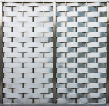 Weave metallic wall with metal frame. It is made of stainless steel.