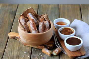 Churros with chocolate sauce, jam and caramel