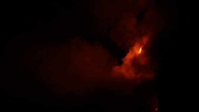 Lava flowing in the ocean and huge rock falls breaking off from volcanic lava eruption on Big Island Hawaii. Lava lava meets the Ocean in dramatic spectacle. Kilauea volcano. Night shot slow motion.