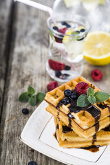 Belgian waffles with raspberries, blueberries and mint, covered