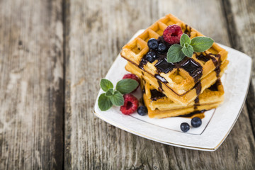 Belgian waffles with raspberries, blueberries and mint, covered