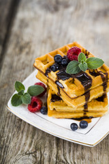 Belgian waffles with raspberries, blueberries and mint, covered