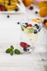 Homemade lemonade with fresh berries on a wooden table.Cocktail