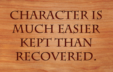 Character is much easier kept than recovered - quote on wooden red oak background