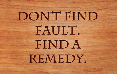 Don't find fault.  Find a remedy - a quote on wooden red oak background