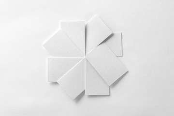 Mockup of blank business cards fan stack at white textured paper