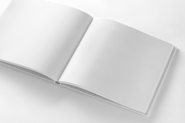 Fototapeta premium Mockup of opened blank square book at white paper background