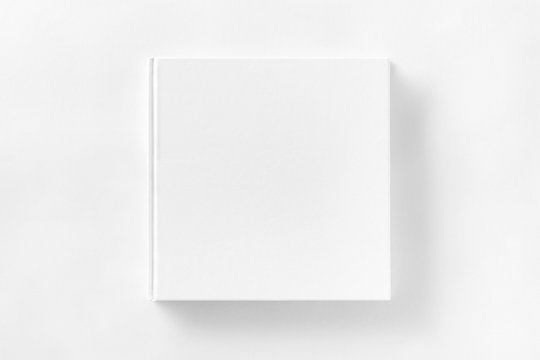 Mockup of closed blank square book at white textured paper 