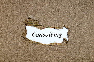 The word consulting appearing behind torn paper