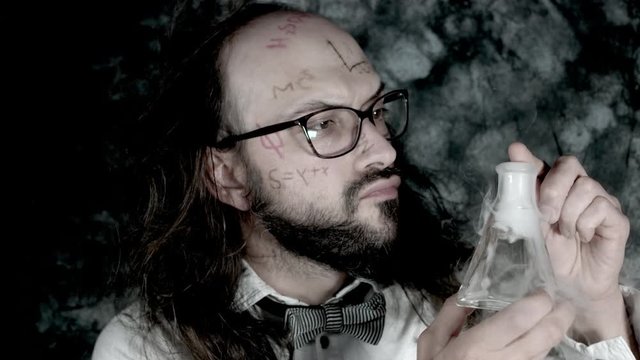4k Crazy Professor Science Man Looking at Toxic Liquid with Smoke