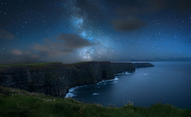 Milky way over dramatic Cliffs of Moher and wild Atlantic Ocean, Ireland