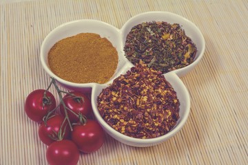 Assorted spices in white bowls