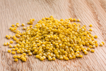 millet groats on wooden background
