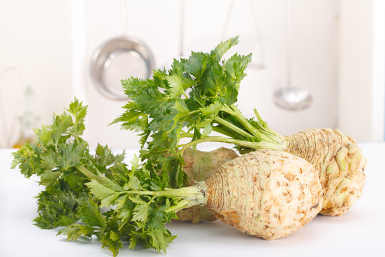 Fresh celery with root leaf in a kitchen