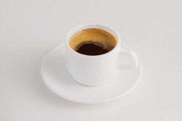 Closeup image of hot cup of espresso coffee isolated