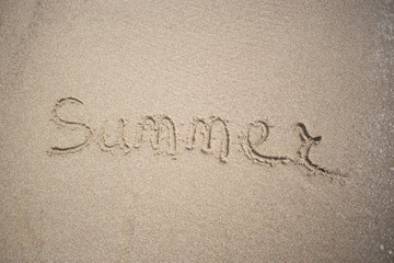 Hand made text in sand on a beach inscription summer - Sun and Sea