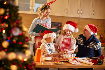 Family with children preparing cookies for Xmas.