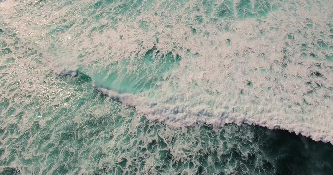 Aerial footage of incredible ocean waves. Drone view of wide andle ocean waves.