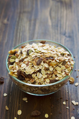 oat with dry fruit in white bowl on brown backround