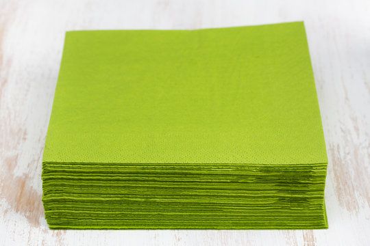 Green Paper Napkin On White Wooden Background