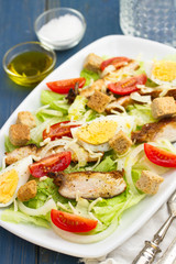 chicken salad with boiled egg on white dish