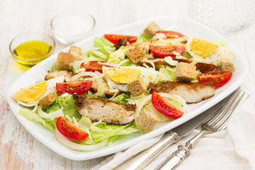 chicken salad with boiled egg on white dish