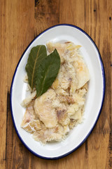dry cod fish on dish on wooden background