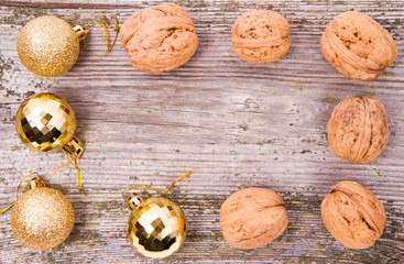 Walnuts and christmas balls on a wooden backgrounds
