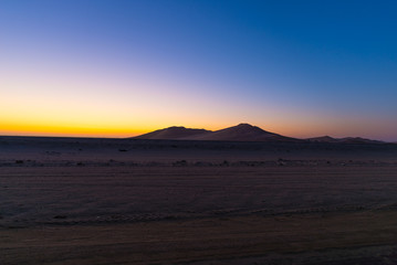 Fototapeta na wymiar Colorful sunset over the Namib desert, Namibia, Africa. Scenic sand dunes in backlight in the Namib Naukluft National Park, Swakopmund.