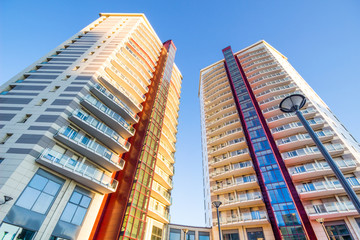 Condominium or apartment building / image of condo buildings with sunshine.