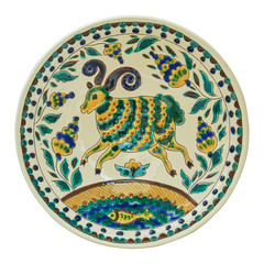 Covered with glaze ceramic plate handmade. Isolated on a white b