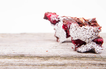 Christmas tree shaped raspberry brownies covered with powdered sugar on a wooden background