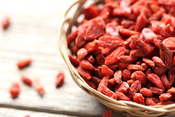 Dry goji berries on grey wooden table