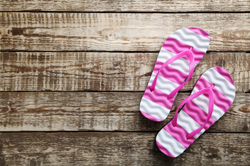 Flip flops on a grey wooden table