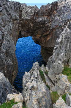 Rocky arch near shore, Spain.
