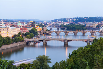 Fototapeta na wymiar Panorama of the old part of Prague from the Letna park at dusk. Beautiful view on the bridges over the river Vltava at sunset. Old Town architecture, Czech Republic.