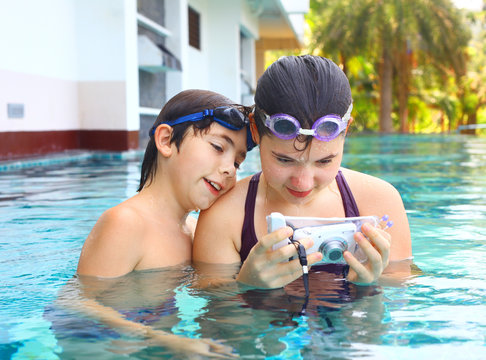 boy and girl make underwater camera shoot