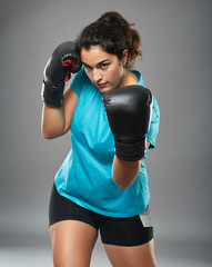 Latino female fighter throwing an uppercut