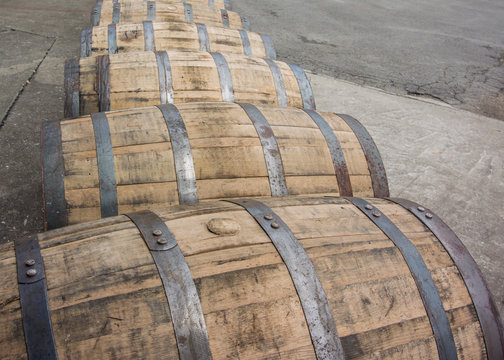 Bend in Row of Rolling Bourbon Barrels